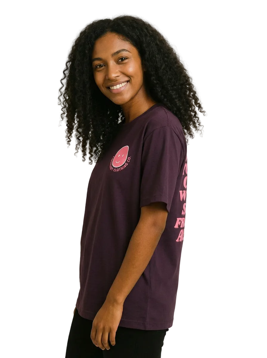 Person wearing a purple t-shirt with a logo and text on a plain background