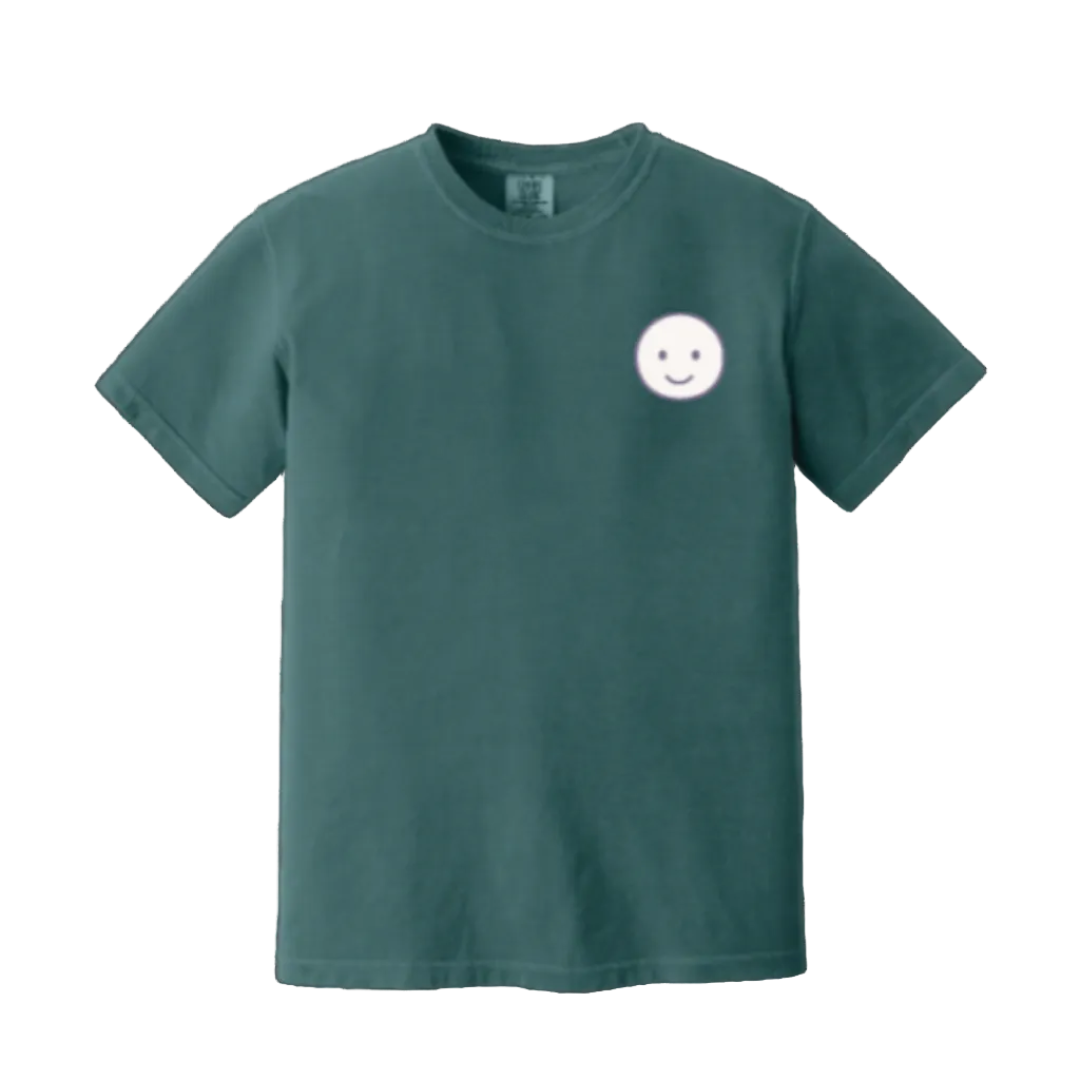 Green t-shirt with a smiley face design on a white background