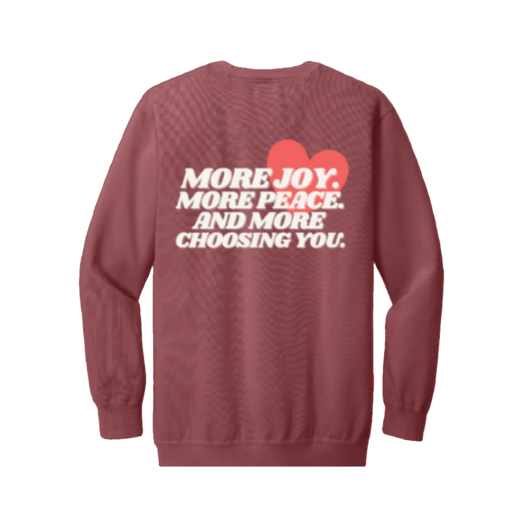 Crimson sweatshirt with white text and a red heart on the back