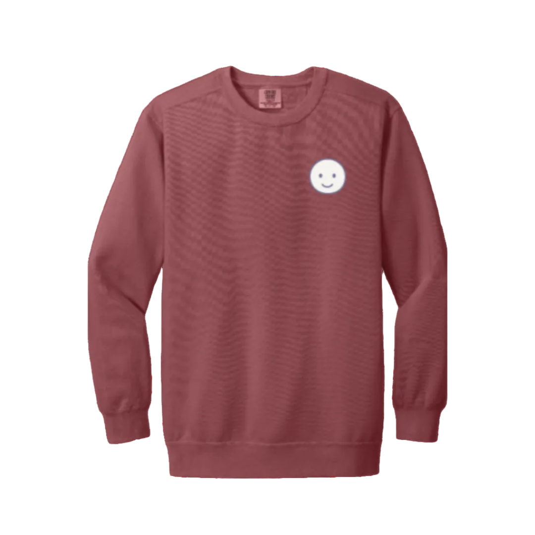 Crimson sweatshirt with a white smiley face logo on a white background