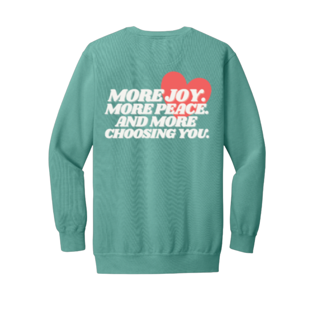 Seafoam sweatshirt with motivational text and a red heart on the back against a white background