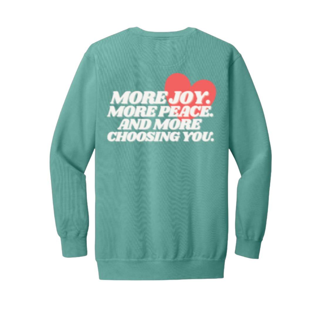 Seafoam sweatshirt with motivational text and a red heart on the back against a white background