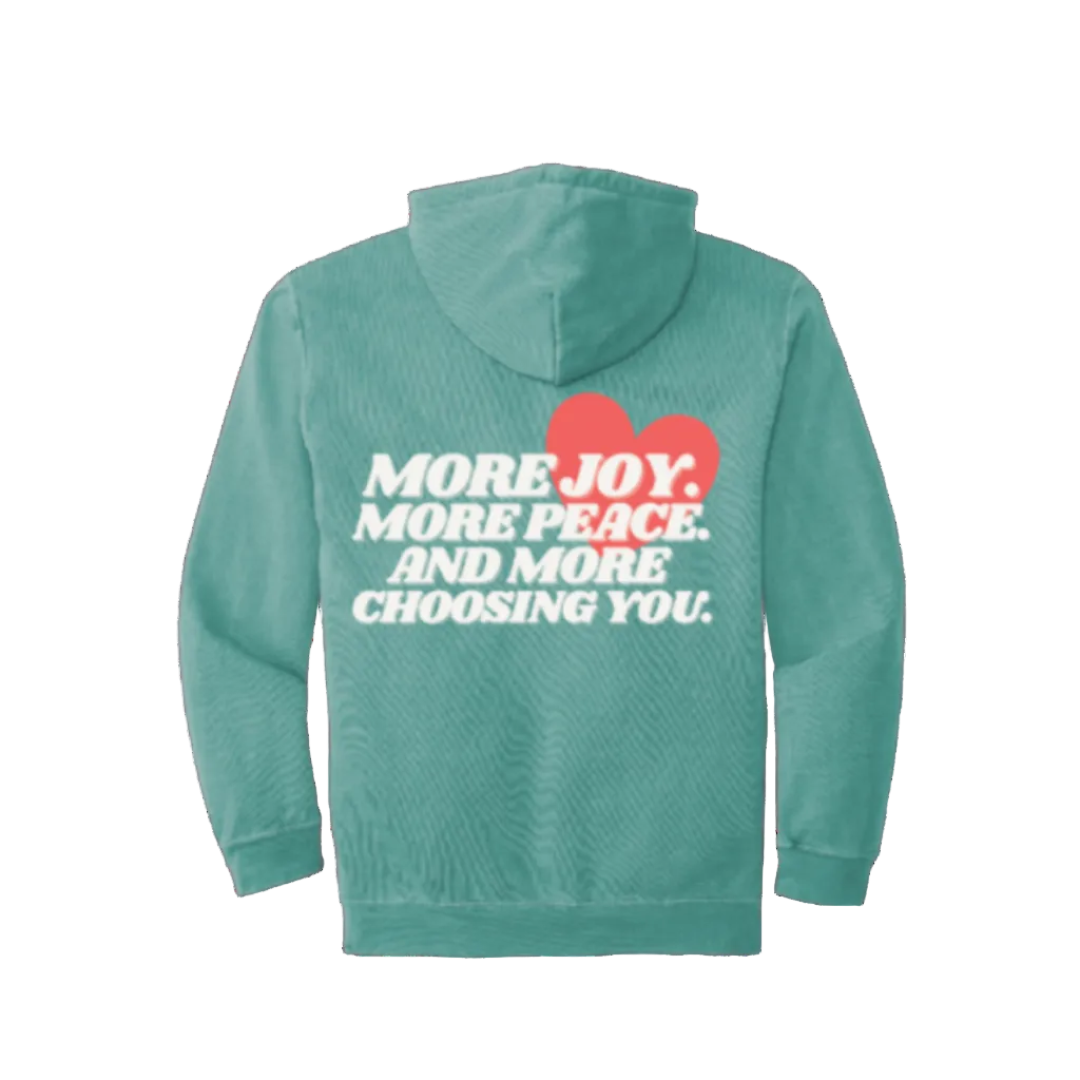 Seafoam hoodie with text and heart design on the back against a white background