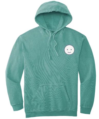 Teal hoodie with a white smiley face patch on a red background