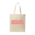 Beige tote bag with red text 'MADE FOR THE GENTLE ESSENTIALS' on a white background
