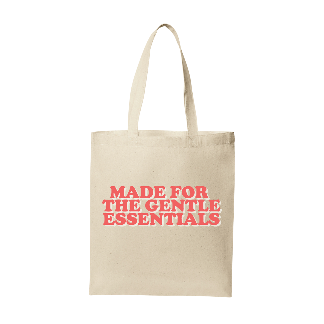 Beige tote bag with red text 'MADE FOR THE GENTLE ESSENTIALS' on a white background
