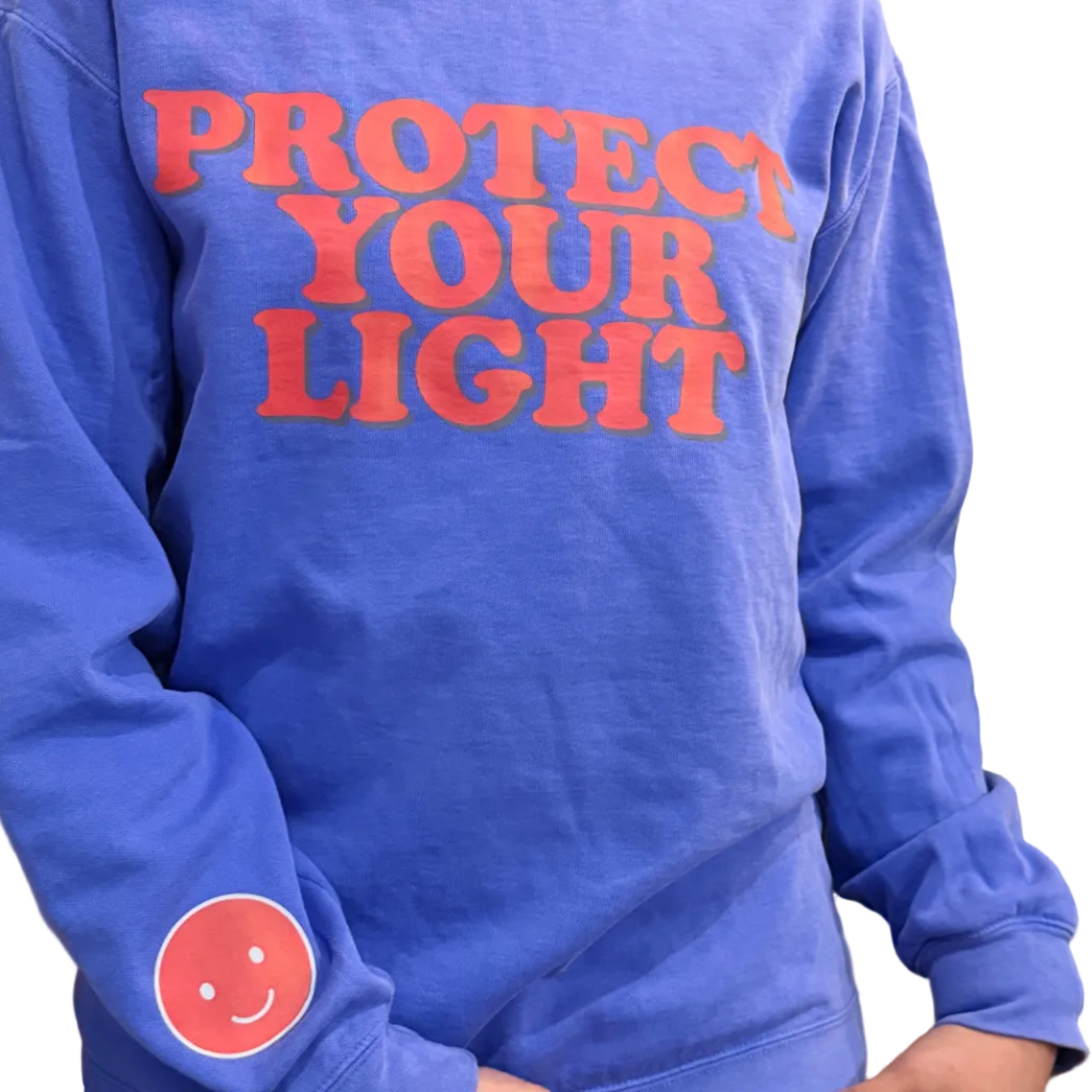 Blue sweatshirt with 'Protect Your Light' text and smiley face design on a person wearing it.