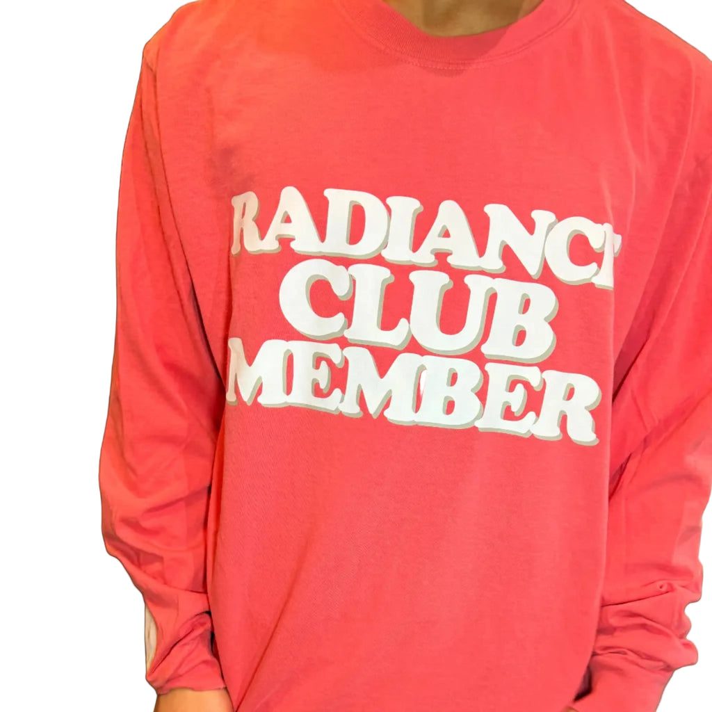 Person wearing a pink sweatshirt with 'Radiance Club Member' text.
