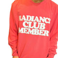 Person wearing a pink sweatshirt with 'Radiance Club Member' text.