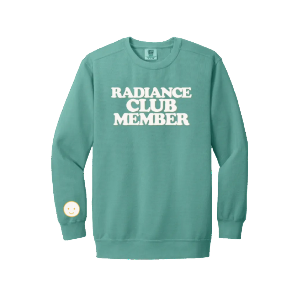 Teal sweatshirt with 'Radiance Club Member' text on a white background