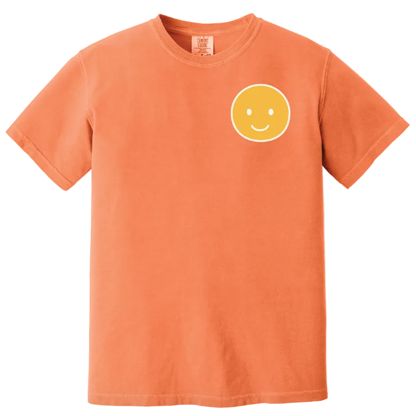 Orange t-shirt with a yellow smiley face on a white background