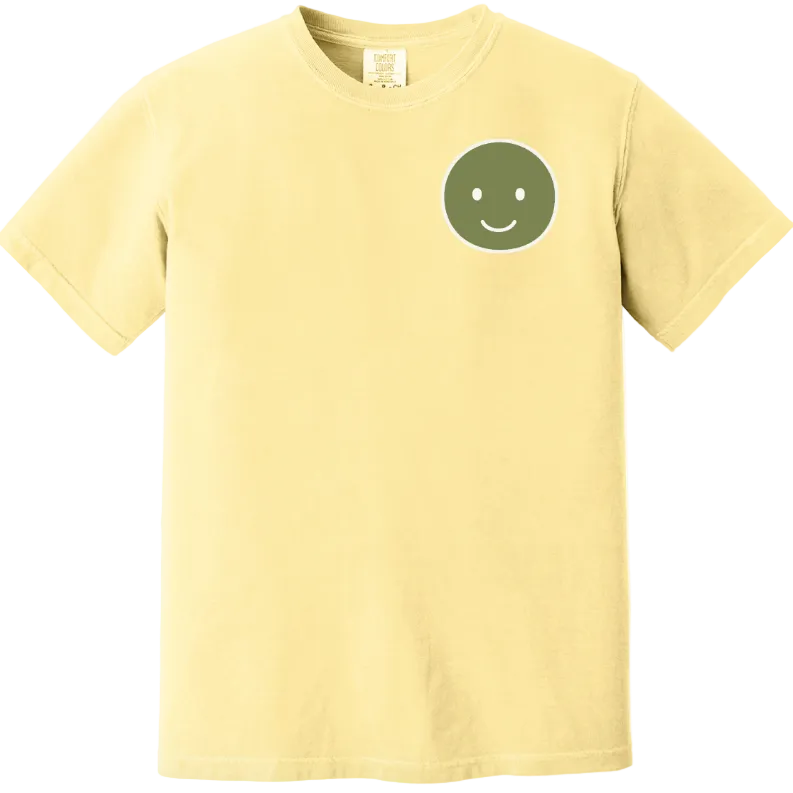 Yellow t-shirt with a green smiley face design on a white background