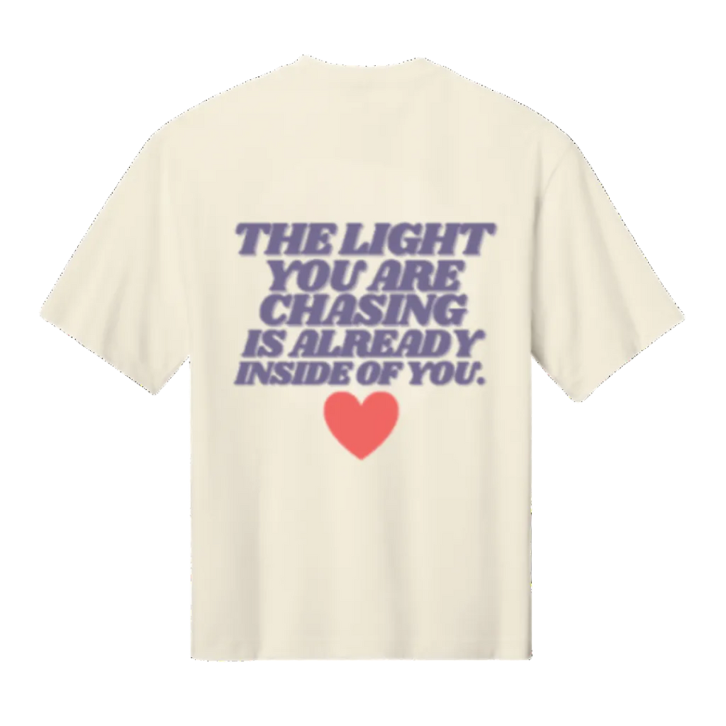 Beige t-shirt with motivational quote and heart graphic on a white background