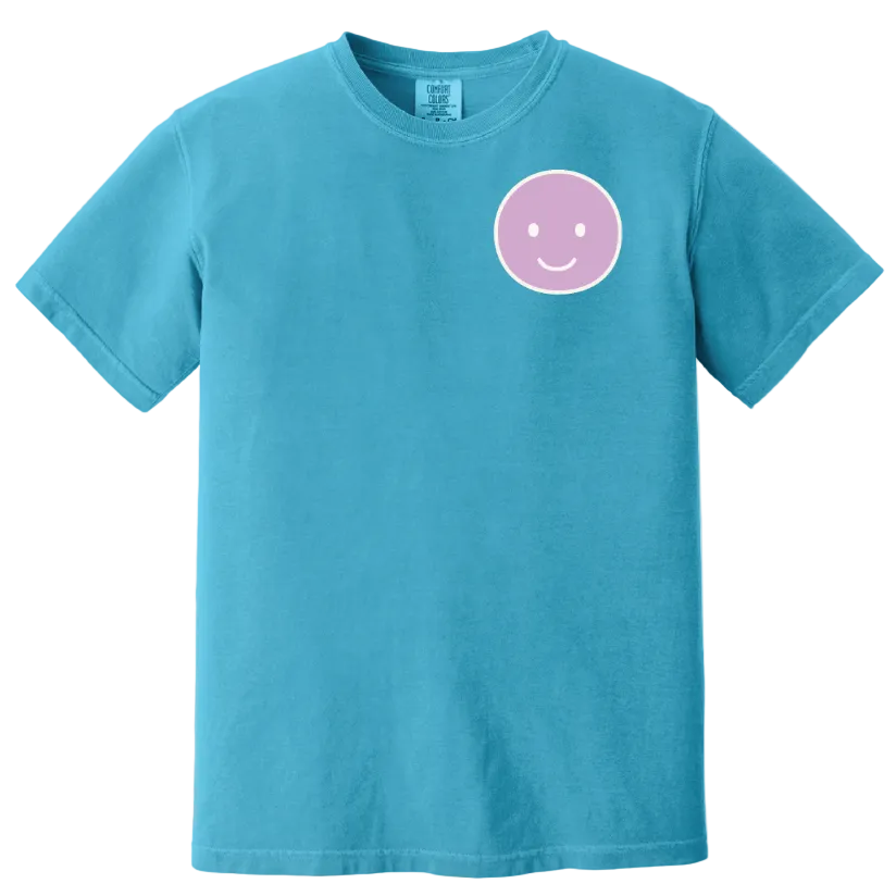 Blue t-shirt with a pink smiley face design on a white background