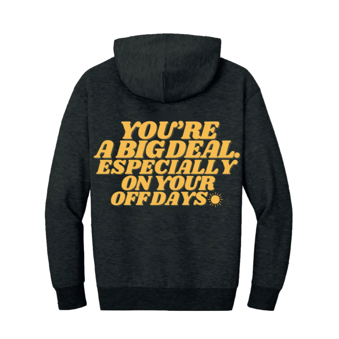 Black hoodie with yellow text on a white background