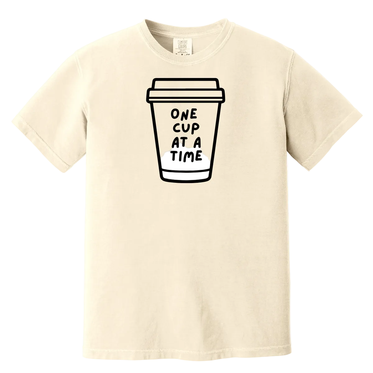 Beige t-shirt with a coffee cup graphic and text 'ONE CUP AT A TIME' on a white background